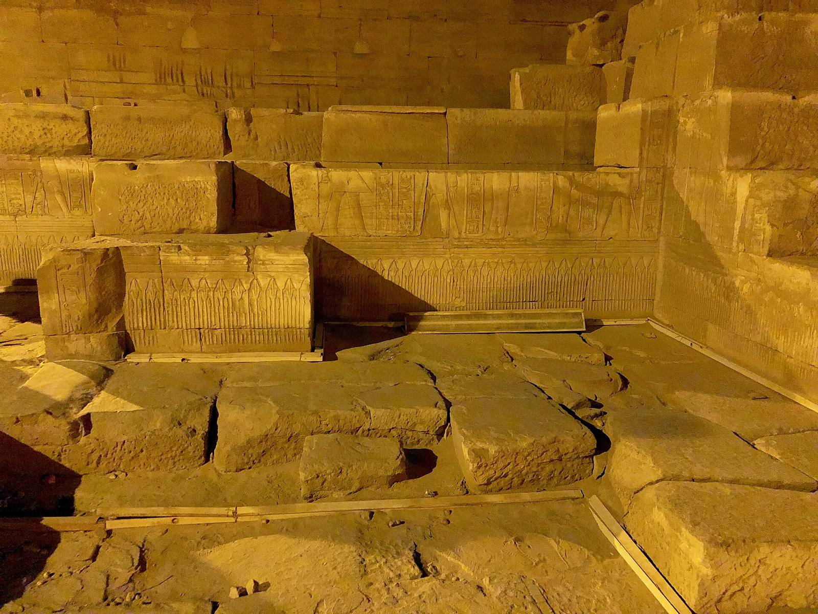 Carved stone blocks and hieroglyph reliefs inside an ancient Egyptian temple